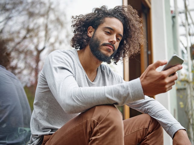 young-man-looking-at-cell-phone-2022-03-08-01-27-38-utc